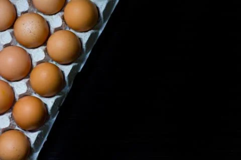 Eggs egg carton box copyspace food box dark wooden board top view top Stock Photos