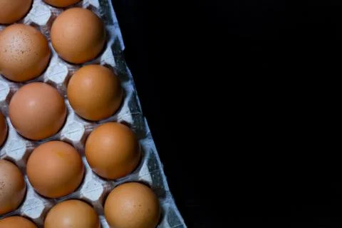 Eggs egg carton box copyspace food box dark wooden board top view top Stock Photos