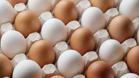 Eggs in egg carton rotating. Uncooked white and brown eggs. Organic food Stock Footage 302744854