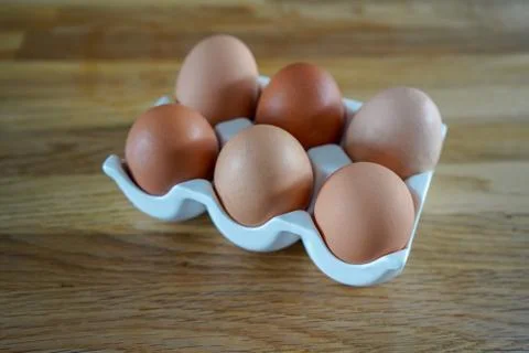 Eggs in a egg holder Stockfoto's