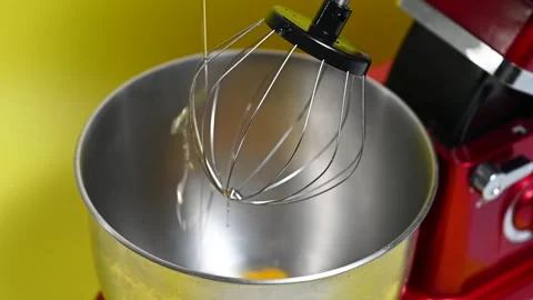 Eggs falling into a mixer bowl Stock-Footage 276360110