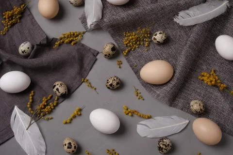Eggs with flowers and decorative elements on concrete. Stock Photos