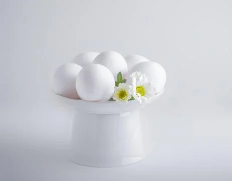 Eggs with flowers on a white background. Easter Symbols. Stock Photos