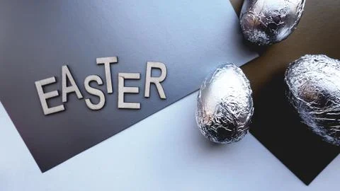 Eggs in foil on silver background. Easter concept. With text Easter Stock Photos
