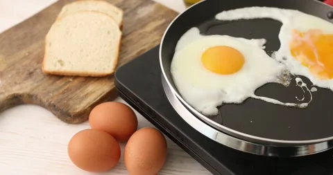 Eggs is fried in a frying pan. Stock Footage 250263293