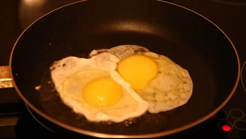 Eggs fried in a pan Stock Footage