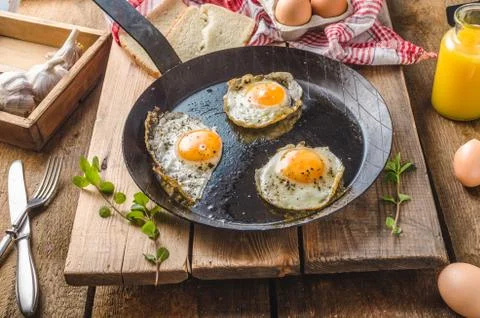 Eggs fried rustic style Stock Photos