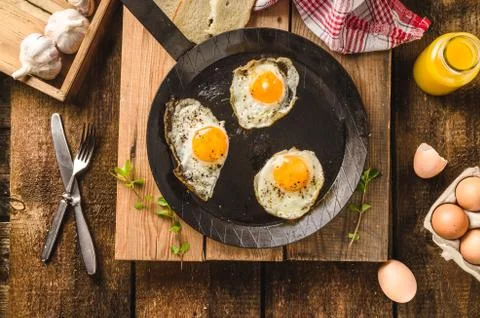 Eggs fried rustic style Stock Photos