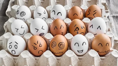 Eggs with funny faces in box. Happy, angry, sad, surprised faces on eggs Stock Footage 303237539