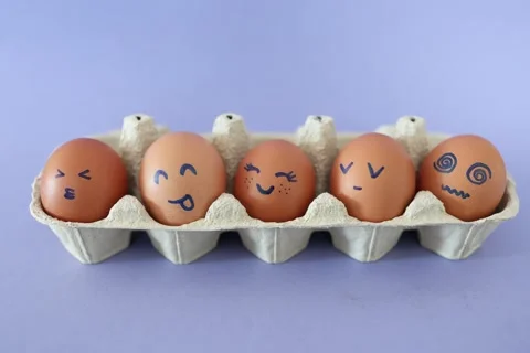 Eggs with funny faces in box. Happy, angry, sad, surprised faces on brown eggs Stock Footage 332162824