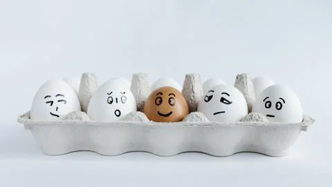 Eggs with funny faces in the package on a white background. Easter Concept . Foto stock