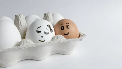 Eggs with funny faces in the package on a white background. Easter Concept . Foto stock