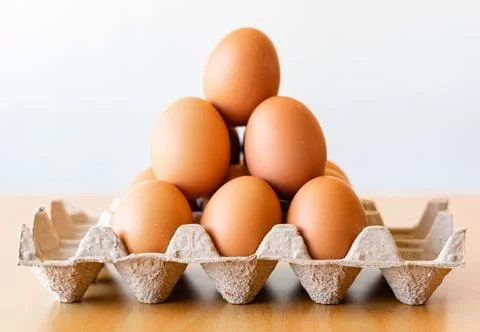 Eggs in a gray container Stock Photos