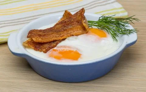 Eggs with grilled bacon Stock Photos