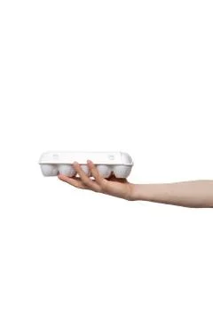 Eggs held in hand isolated on white background. man holding plastic package Stock Photos