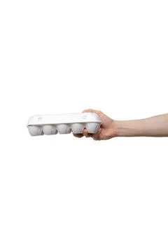 Eggs held in hand isolated on white background. man holding plastic package Stock Photos