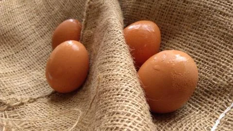 Eggs on  hemp fabric background Stock Photos