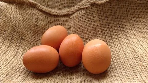 Eggs on  hemp fabric background Stock Photos