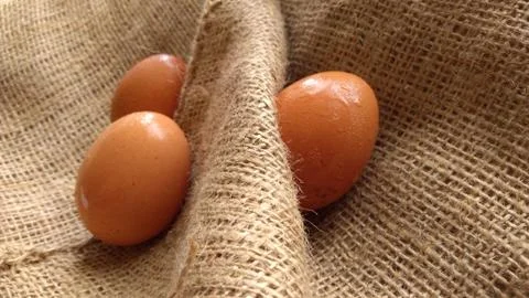 Eggs on  hemp fabric background Stock Photos