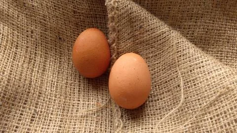 Eggs on  hemp fabric background Stock Photos