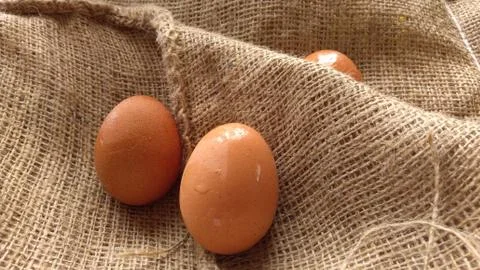 Eggs on  hemp fabric background Stock Photos