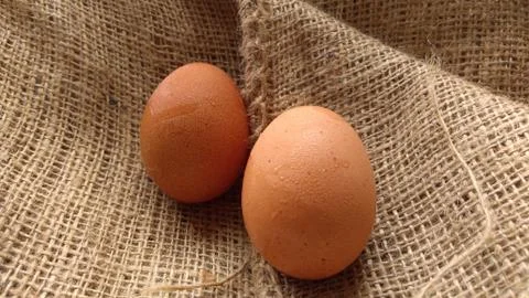 Eggs on  hemp fabric background Stock Photos