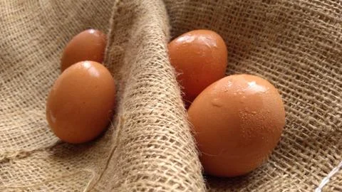 Eggs on  hemp fabric background Stock Photos
