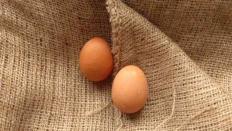 Eggs on  hemp fabric background Stock Photos