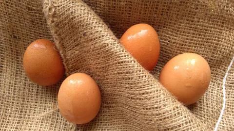Eggs on  hemp fabric background Stock Photos