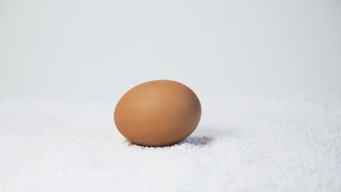 Eggs lay on the white background Stock Footage 127857429