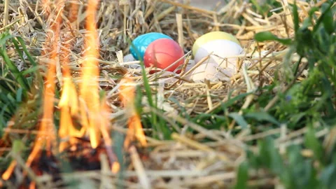 The eggs lie in the hay and the fire burns around.  Easter. Celebration. Stock Footage 108206505