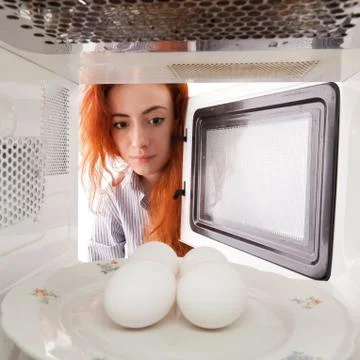 Eggs in microwave Stock Photos