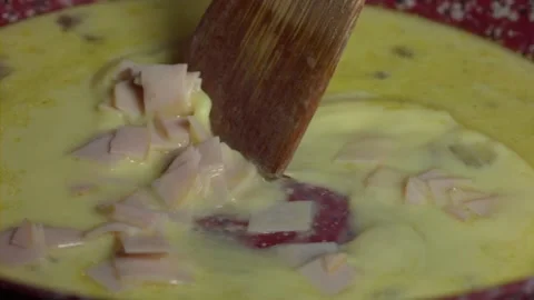 Eggs mixed with turkey ham on frying pan with wood spatula, Slow Motion 500fps Stock Footage 149182298