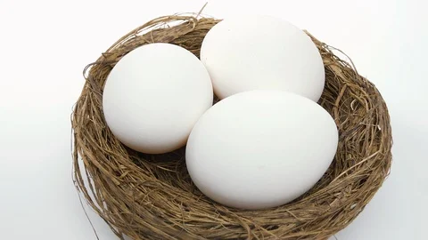 Eggs nest white egg in straw basket rotating Stock Footage 123087767
