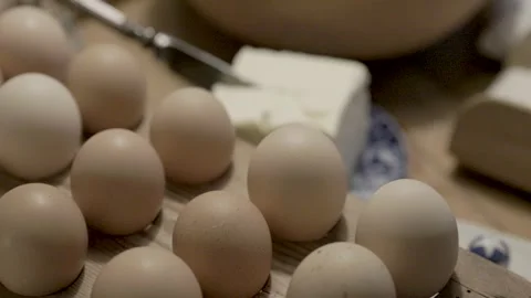 Eggs on an old baking table preparations for baking Stock Footage 234198837
