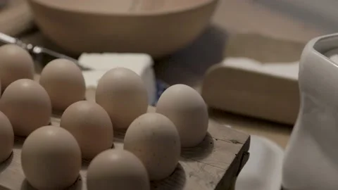 Eggs on an old baking table preparations for baking Stock Footage 234199083