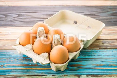 Eggs Pack On Wood Background