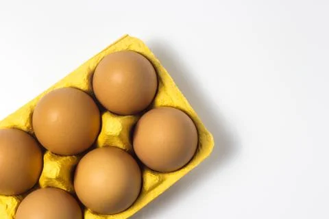 Eggs in a package on a white background Stock Photos
