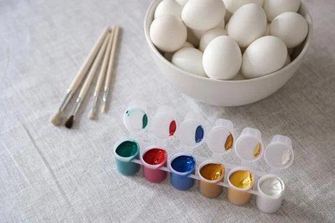 Eggs, paints and brushes on table. Easter concept Photos