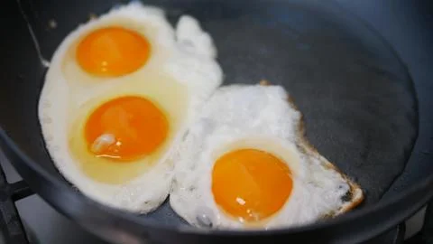 Eggs in a pan cooking Photos