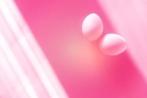 Eggs on a pastel pink background. Stock Photos