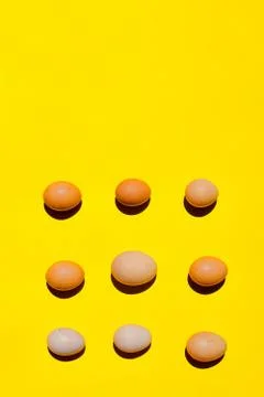 An eggs pattern. A different sizes eggs on a yellow background. Stockfoto's