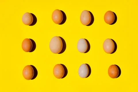 An eggs pattern. A different sizes eggs on a yellow background. 写真素材