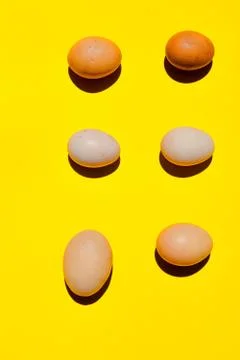 An eggs pattern. A different sizes eggs on a yellow background. Foto stock