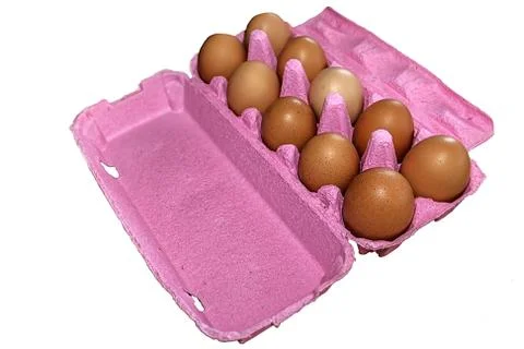 Eggs in pink packaging Stock Photos