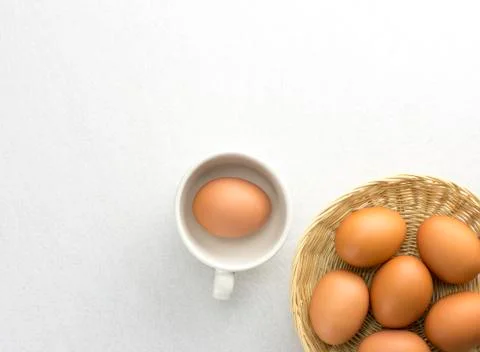 Eggs placed in a woven wooden basket. Stock Photos