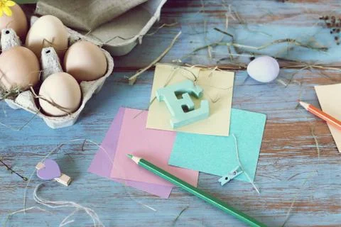 Eggs, quail, easter decor on a blue wooden table, top view Stock Photos