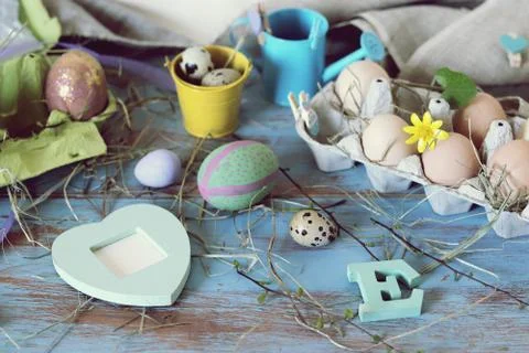 Eggs, quail, easter decor on a blue wooden table, top view Stock Photos