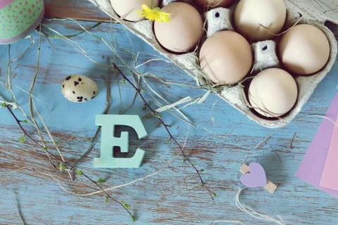 Eggs, quail, easter decor on a blue wooden table, top view Stock Photos