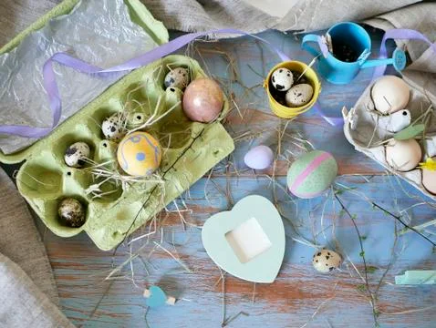 Eggs, quail, easter decor on a blue wooden table, top view Stock Photos